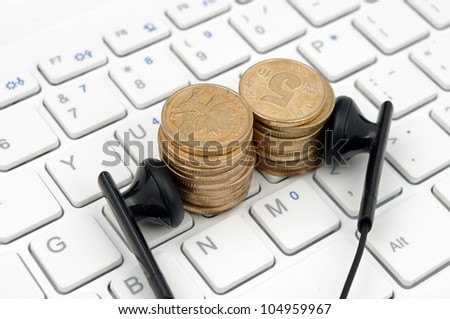 Keyboard headset and money (to express the concept of a paid download and listen to music)