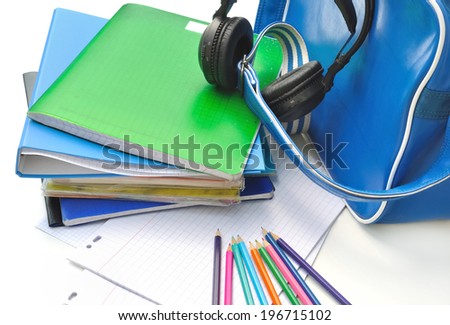 school supplies of a teenager with headphone in blue bag