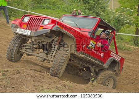 MOHELNICE, CZECH REPUBLIC - JUNE 10. Unidentified racer at red off-road car leaves steep slope in the \