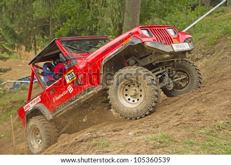 MOHELNICE, CZECH REPUBLIC - JUNE 10. Unidentified racer at red off-road car leaves steep slope in the \