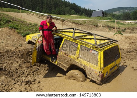 MOHELNICE, CZECH REPUBLIC - JUNE 09. Yellow off road car drowned in muddy terrain in the \
