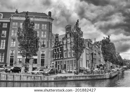 Black and white photo of one of the canals in Amsterdam. (The Netherlands). All potential trademarks are removed.