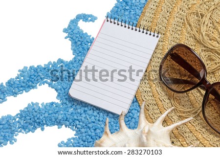 Straw hat, sunglasses, paper notebook and a seashell are lying on a little blue stones forming a wave isolated on the white.