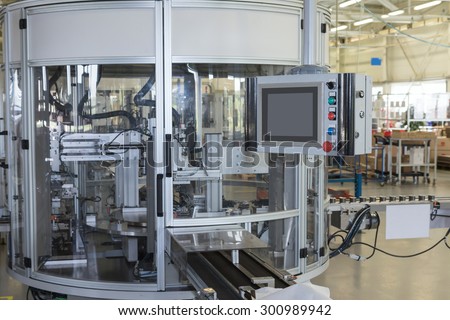 Front view of the automatic production line with a control panel. All potential trademarks are removed.