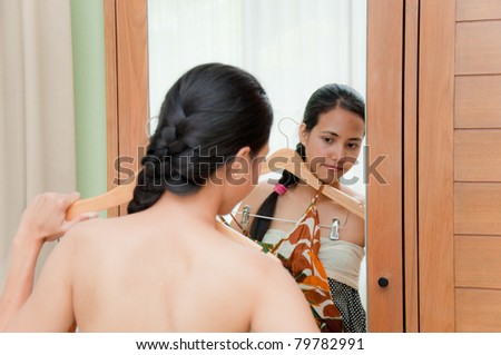 Beautiful Woman try cloth in dressing room