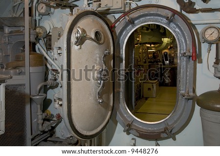 Locked submarine hatch metal door at end of hallway navy