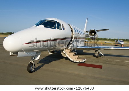 Corporate private luxury jet at airport door open blue sky