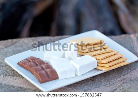 ingredients for smores (marshmallow, graham crackers and chocolate) ready for cooking, shallow DOF