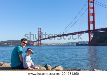 happy father and son enjoying san francisco and golden gate bridge