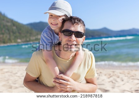 cheerful family of two having fun during vacation at lake tahoe, california, usa