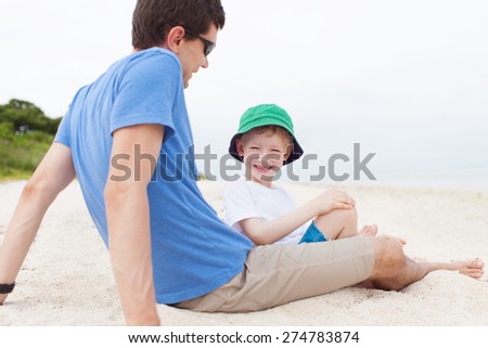 father and his son spending fun day together at the beach at taketomi islands, okinawa, japan