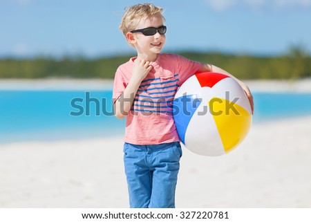 little boy with beach ball enjoying tropical vacation at bahamas