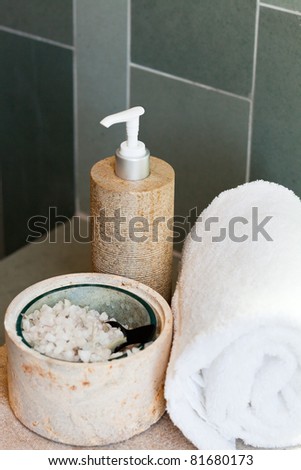 bath dispenser, bath salt and white towel on the tray