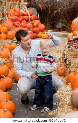 happy father and son at the pumpkin patch
