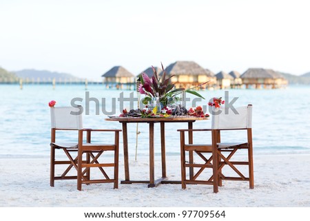 table setting ready for a romantic dinner at the beach