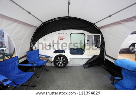 DUSSELDORF - AUGUST 27: Small camper Caretta with awning at the Caravan Salon Exhibition 2012 on August 27, 2012 in Dusseldorf, Germany