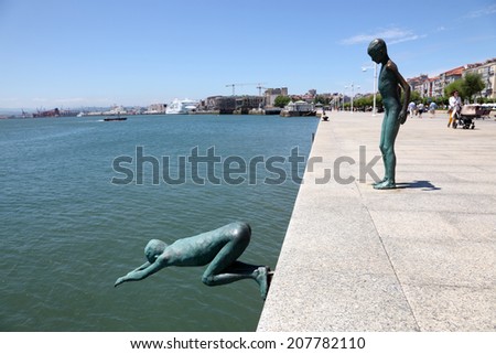 SANTANDER, SPAIN - JUN 30: Los Raqueros - boys jumping into the ocean - sculpture at the promenade of Santander. June 30, 2014 in Santander, Cantabria, Spain