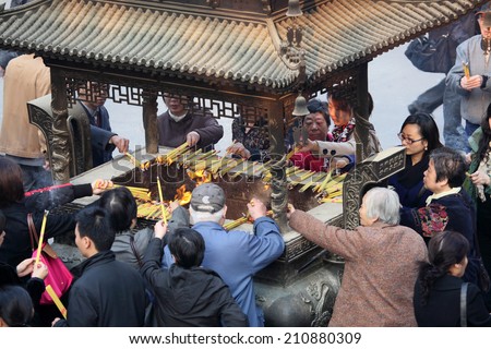 SHANGHAI, CHINA - NOV 20: People praying in a buddhist temple in Shanghai. November 20, 2010 in Shanghai, China