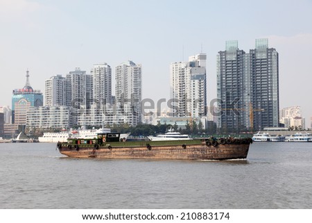 SHANGHAI, CHINA - NOV 18: Barge on the Huangpu river in Shanghai.  November 18, 2010 in Shanghai, China