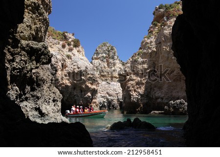 LAGOS, PORTUGAL - JUNE 23: Tourists discovering the cliffs in Algarve. June 23, 2010 in Lagos, Portugal