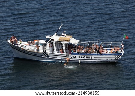 LAGOS, PORTUGAL - JUNE 16: Tourist party boat anchoring at the Algarve coast. June 16, 2012 in Lagos, Algarve, Portugal