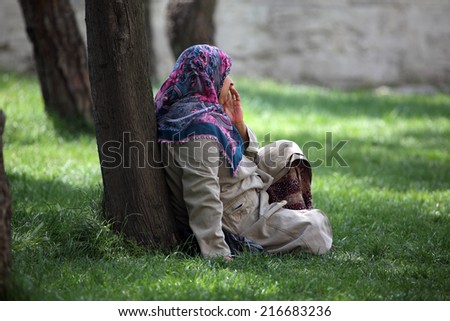 ISTANBUL, TURKEY - MAY 21: Muslim woman takes a rest in a city park. May 21, 2011 in Istanbul, Turkey