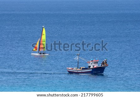 FUERTEVENTURA, SPAIN - JUNE 1: Fishing boat and sailing yacht in the atlantic ocean near Morro Jable. June 1, 2009 on Canary Island Fuerteventura, Spain