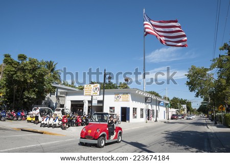 KEY WEST, USA - NOV 19: Tourists riding through the city of Key West in electric car. November 19, 2009 in Key West, Florida, USA