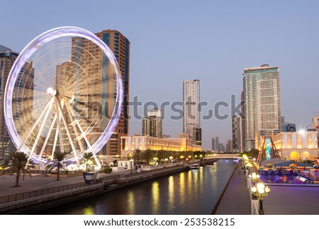 SHARJAH, UAE - DEC 20: Eye of the Emirates Ferris Wheel in Sharjah City at dusk. December 20, 2014 in Sharjah, United Arab Emirates