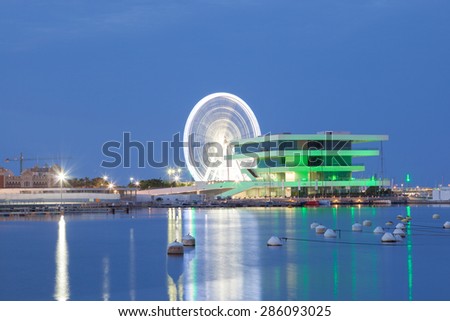VALENCIA, SPAIN - MAY 24: Americas Cup building and Ferris Wheel in the port of Valencia illuminated at night. May 24, 2015 in Valencia, Spain