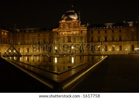 Louvre Museum by night in Paris, France