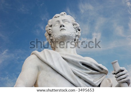 Ancient Roman statue against blue sky