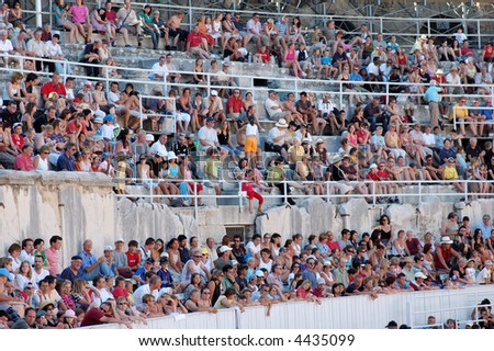Spectators of a bullfight in the Roman arena in Arles, France