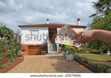 Hand with Euro notes - symbolic for rent or buy a house