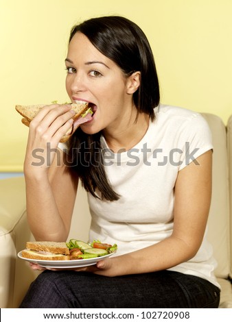 Young Woman Eating Sandwich