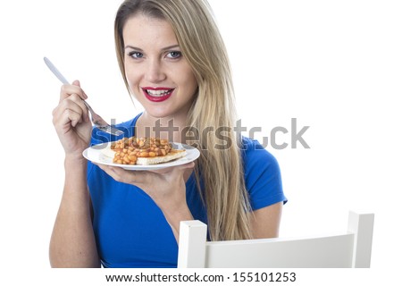 Model Released. Attractive Young Woman Eating Baked Beans on Toast