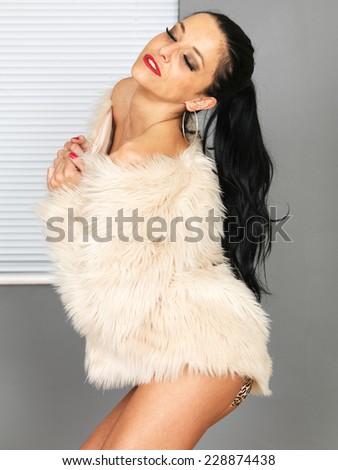 Beautiful Young Woman Wearing a Fur Jacket