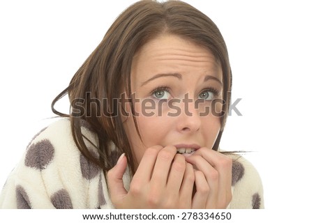 Head Shot of an Attractive Nervous Frightened Young Woman In Her Twenties Biting Her Nails in Fear