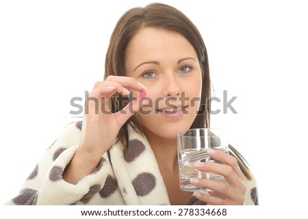 Attractive Young Woman In Her Warm Cosy Dressing Gown Feeling Poorly and Unwell Taking Medicine