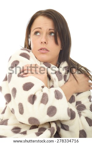 Frightened Scared Attractive Young Woman Against A White Background Wearing A Warm Cosy Dressing Gown