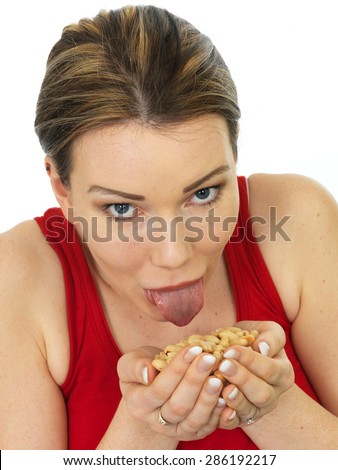 Attractive Happy Young Woman Holding A Handful Of Salted Roasted Peanuts