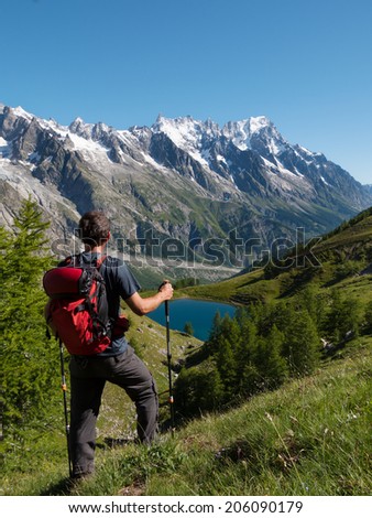 Similar – Image, Stock Photo Man admiring mountain landscape from wooden footbridge