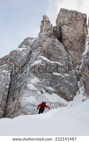 Mountaineer on the snowy steep north face of Torri di Falzarego peak - Cortina d'Ampezzo, Dolomiti, Italy, Europe.