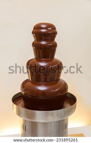 chocolate fountain hot liquid flowing down tower pyramid