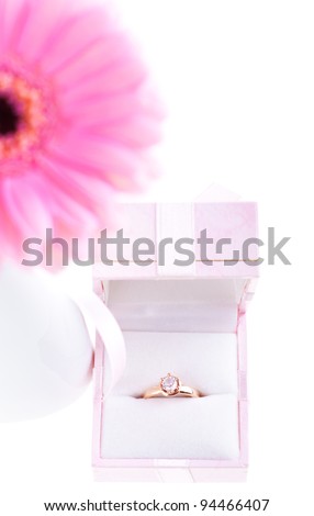 Wedding ring, gift box, flower on the white background. Marriage proposal concept.