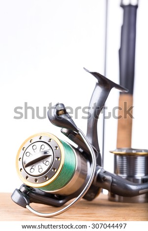fishing rod and reel with line on white background