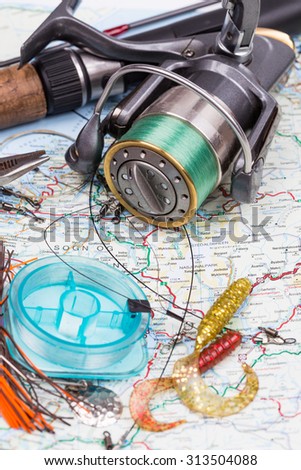 fishing tackles - rod, reel, line and lure on norway map background. Prepare fishing  route and to journey