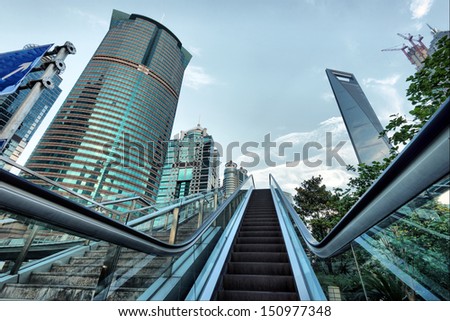 Escalator of Shanghai streets, skyscraper buildings.