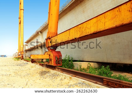 Bridge construction site, bridge cranes and cement slab.