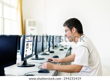 Asian man in front of the computer work